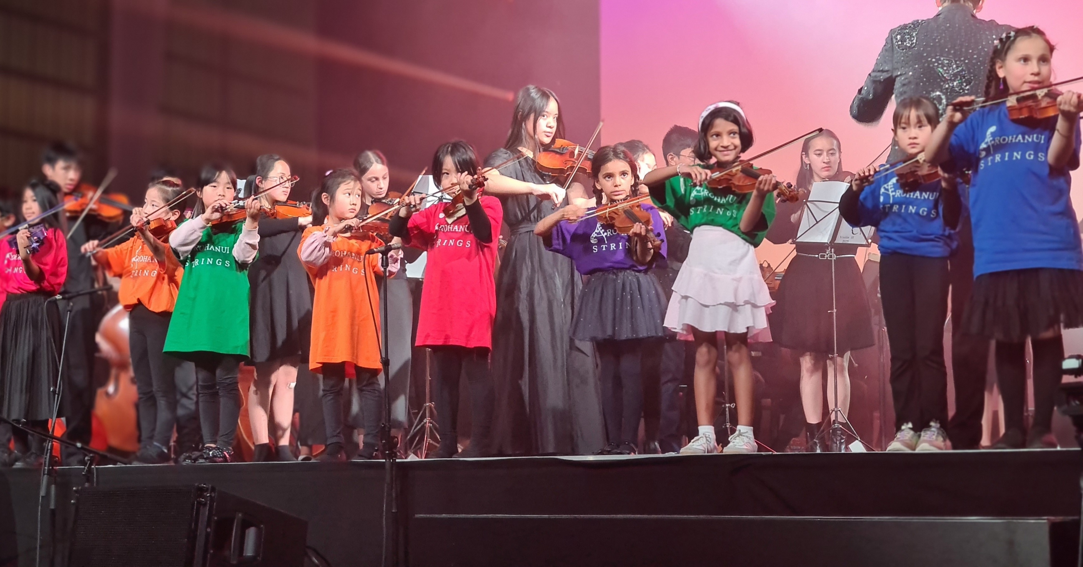 Arohanui Strings+ children performing together on stage